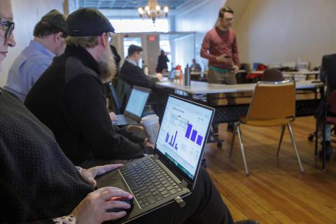 People work on graphs on laptops